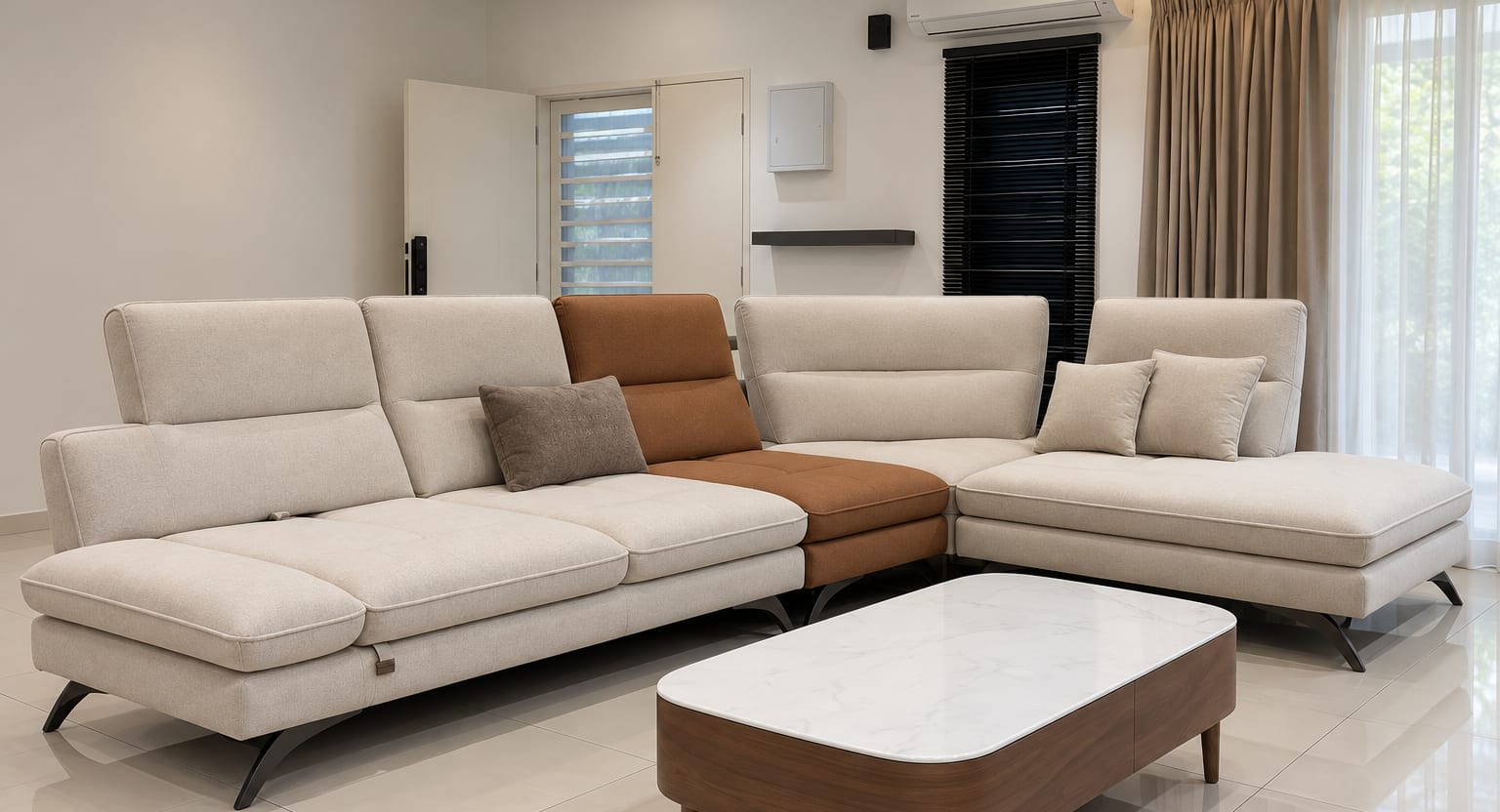A large cream sectional sofa with a tan chaise and a marble-topped coffee table in a bright, finished living room.