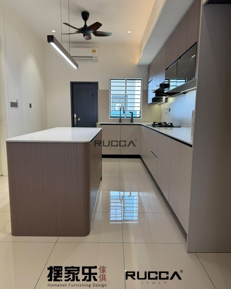 An L-shaped kitchen run with a tall unit and an island.